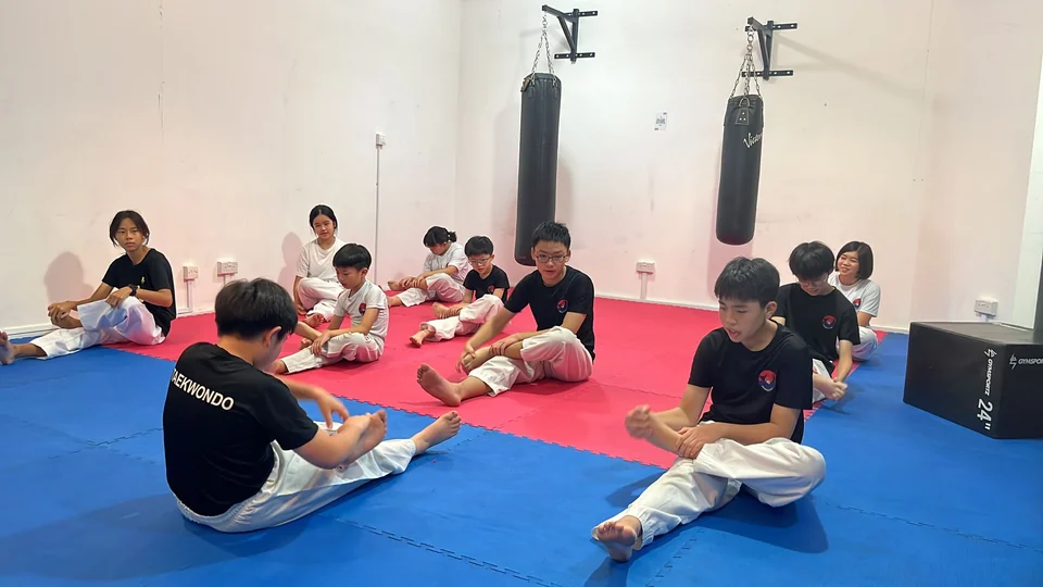 Teenagers having their Taekwondo training with Momentum in their Singapore's gym