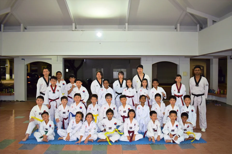 Old Taekwondo group photo from 2012 taken in Singapore. Students and trainers of Momentum Taekwondo