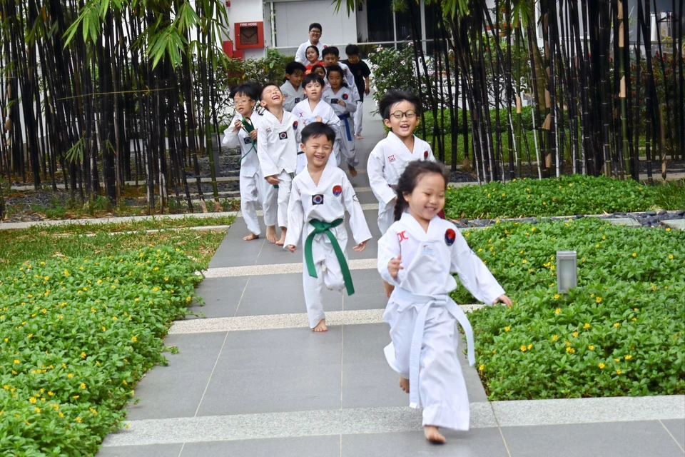 Singaporean kids doing warm-up and getting ready for their Taekwondo training.