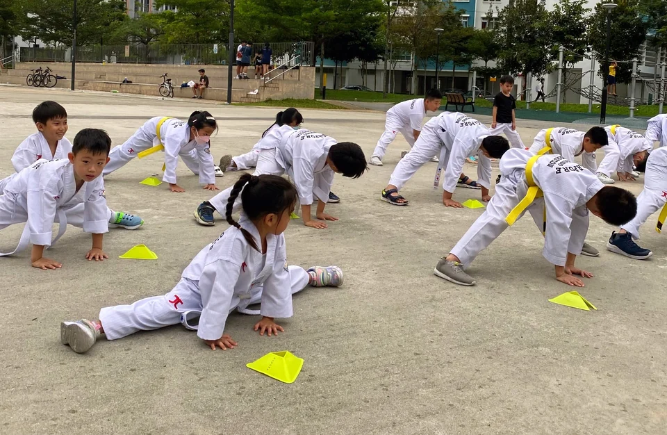 Kids doing stretching during their Taekwondo lesson in Singapore